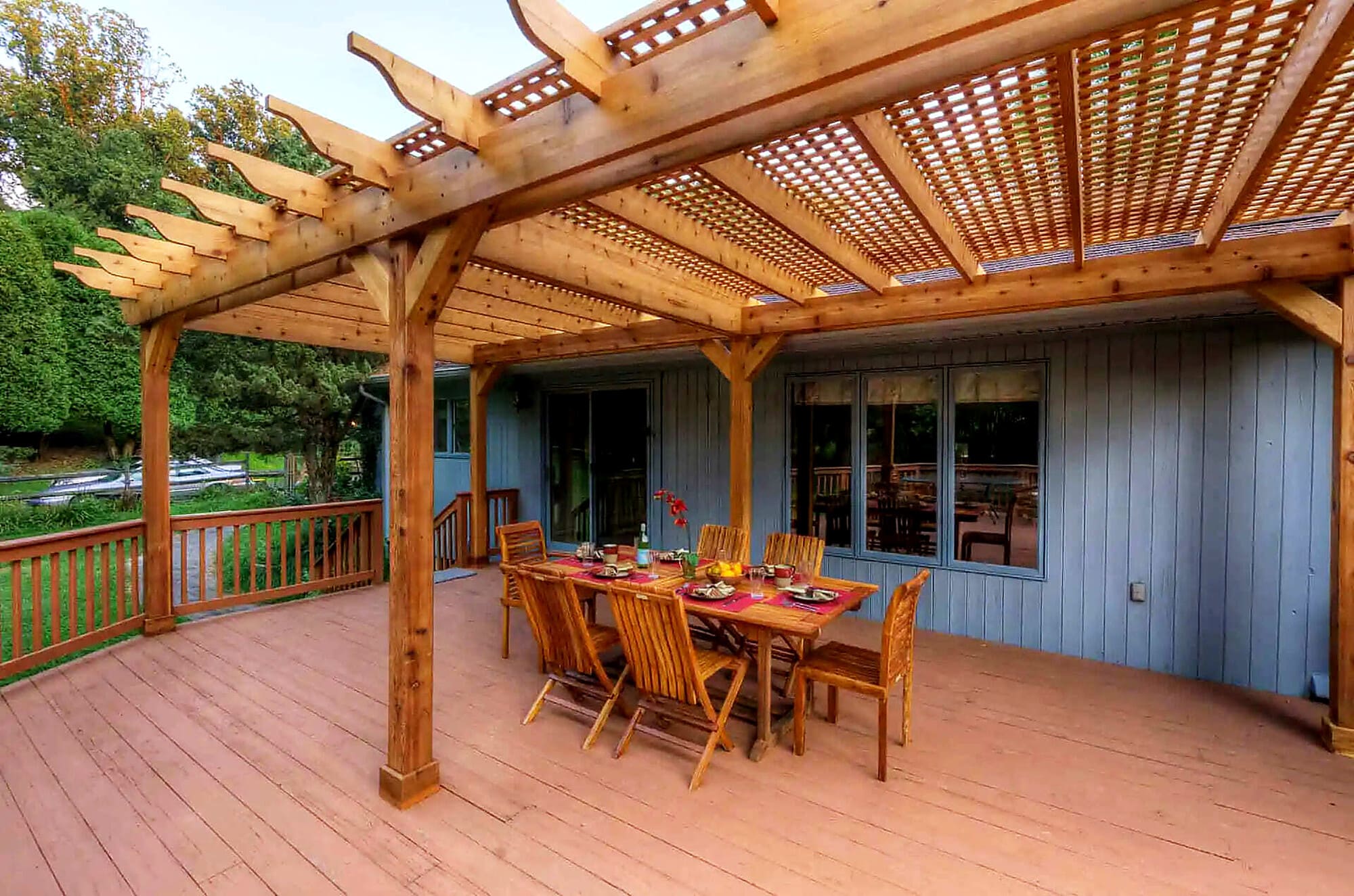 Outdoor Structure: Covered deck with wood pergola, lattice roof, and outdoor dining area in Delaware County, PA