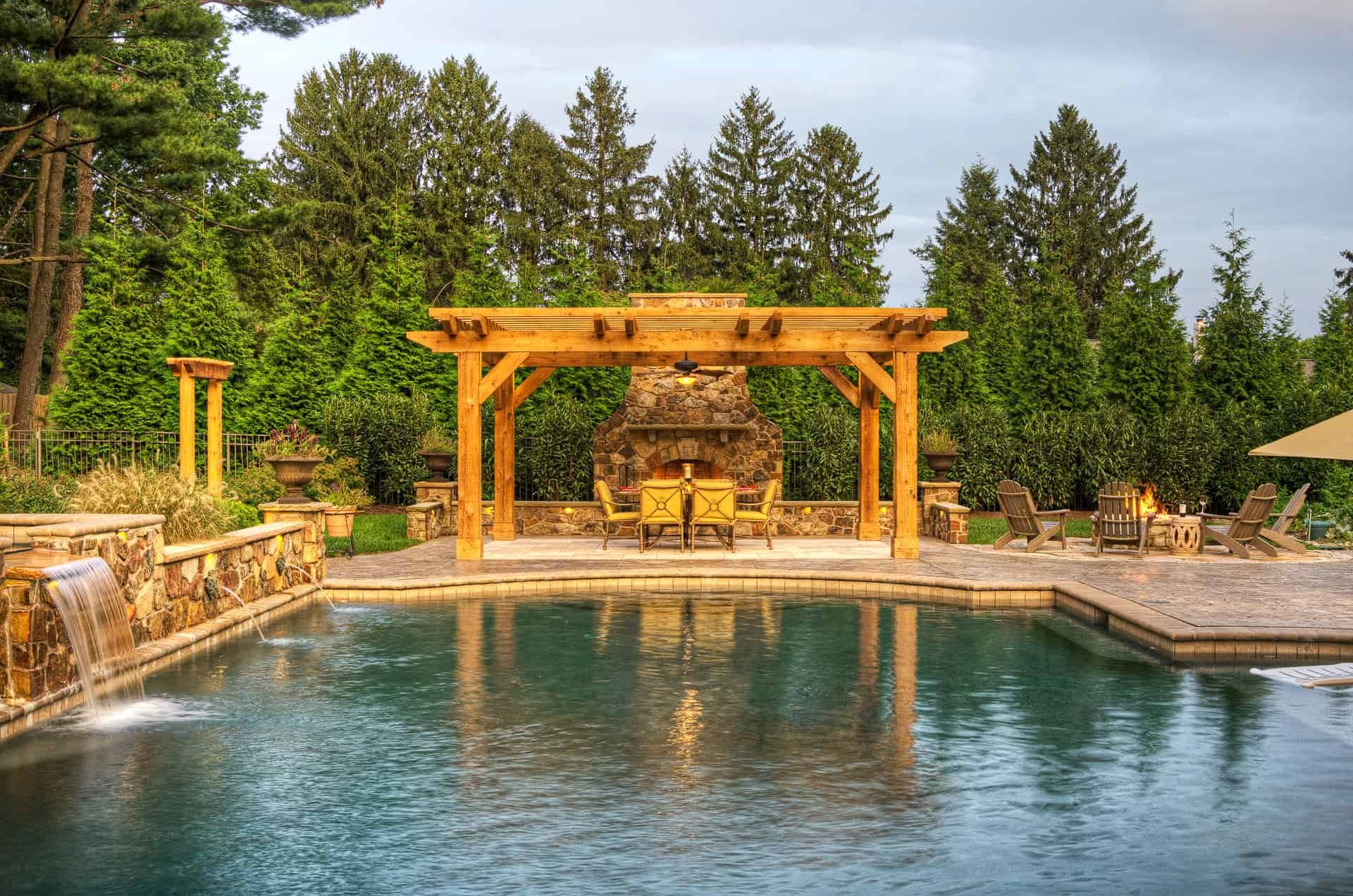 Pergola by pool featuring a fireplace and hardscaping