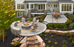 Round-Slate-Patio-with-stone-firepit-and-stone-walls-MILLER-1-1920x1219