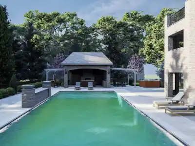Outdoor living in Delaware County, PA, is enhanced by a clear pool surrounded by stone paving. Two lounge chairs invite relaxation beside the water. In the background, a covered patio with dining and barbecue areas adds to the charm, while lush greenery completes this picturesque setting.