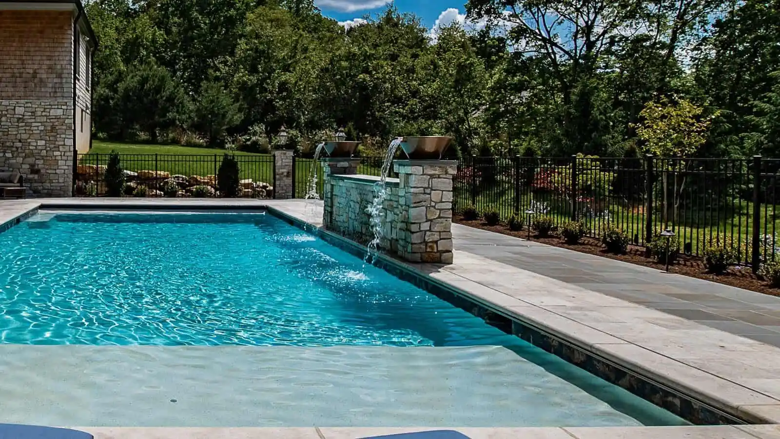 Professional hardscapers designing a luxury poolside at Belazi Pool