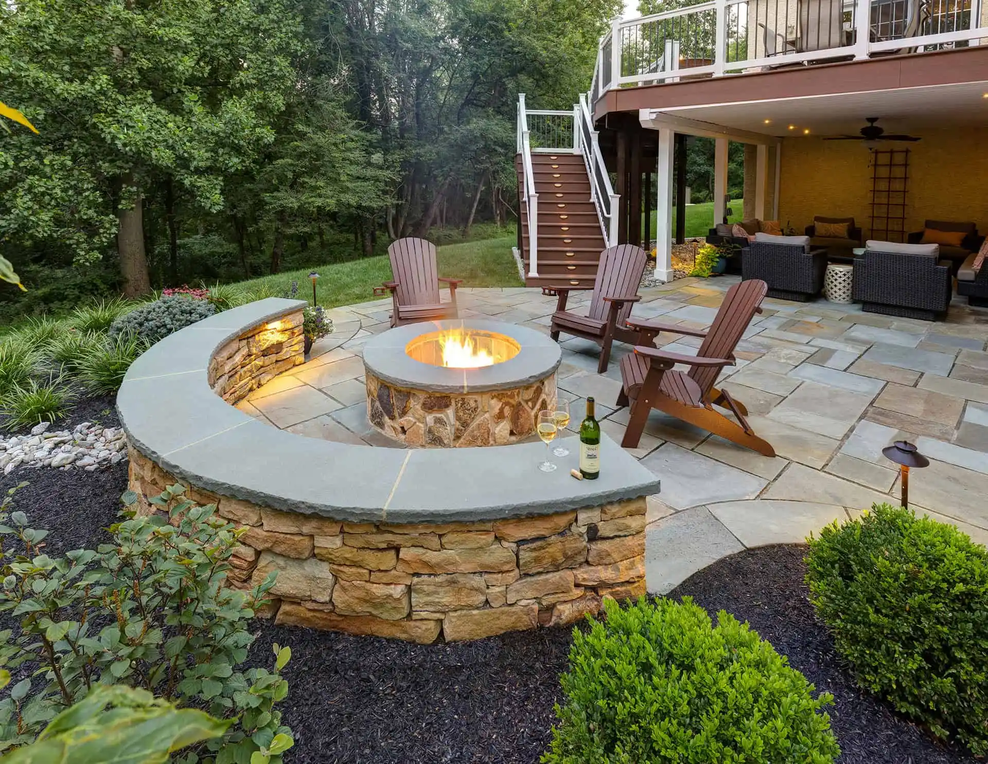 Cozy backyard patio with fire pit and seating by expert hardscapers