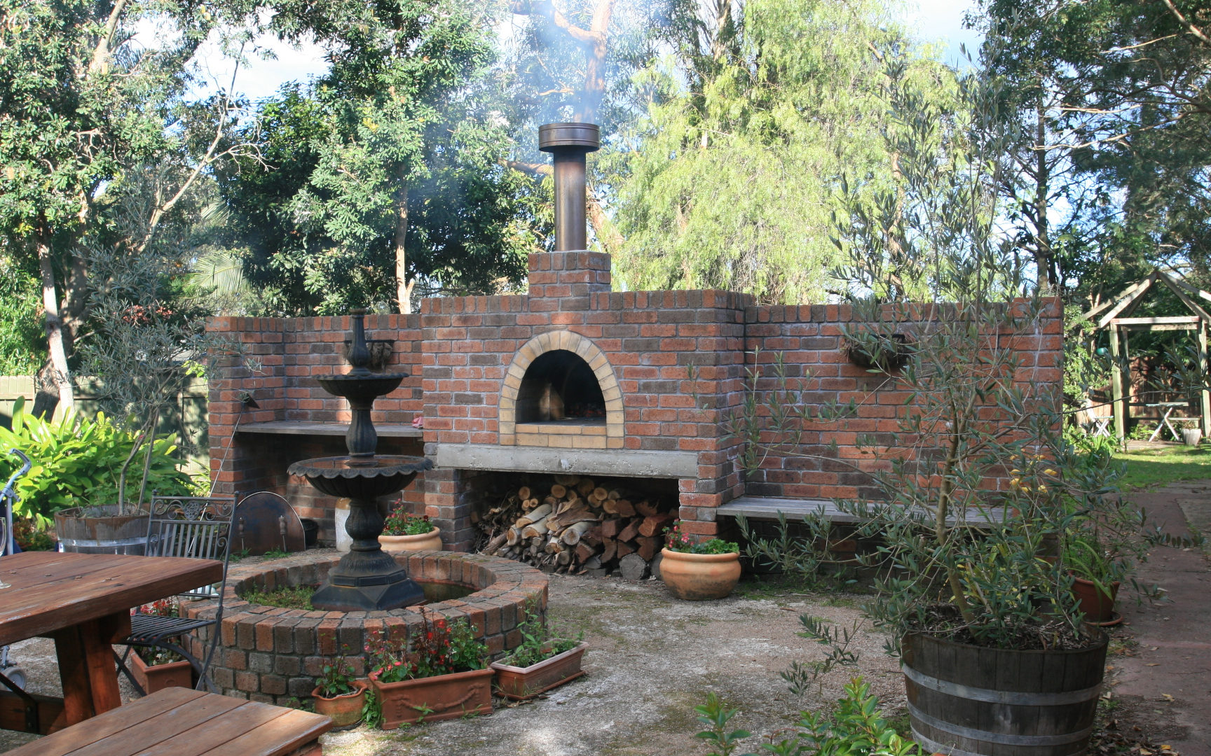 Outdoor Stone Kitchen With Firebrick Pizza Oven and Large